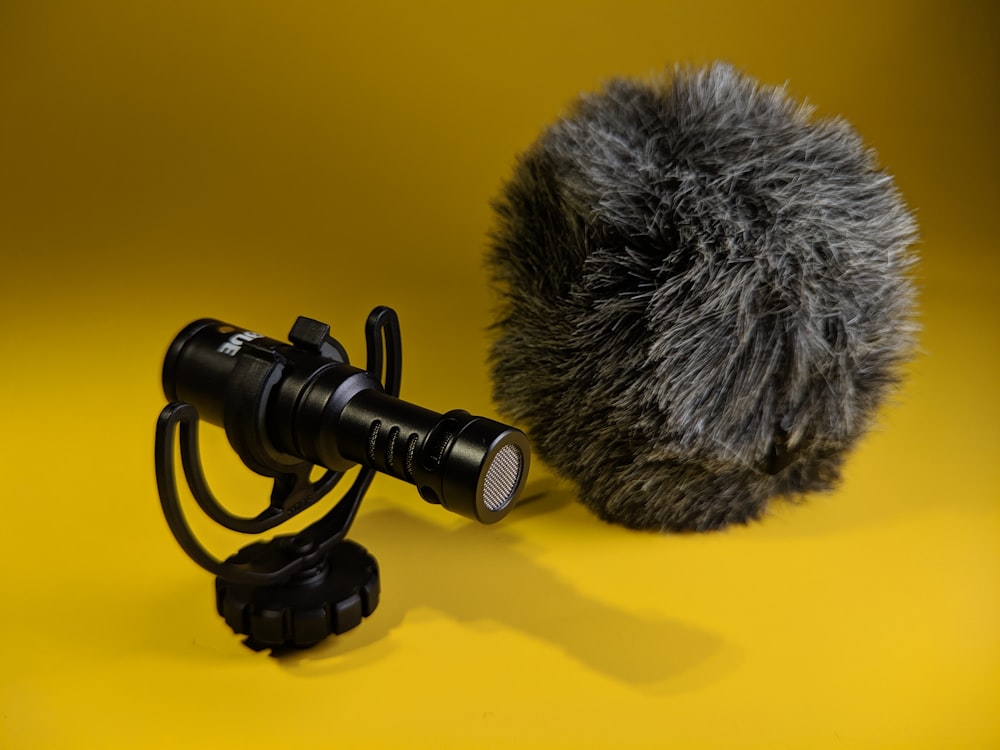 a close up of a microphone on a yellow background