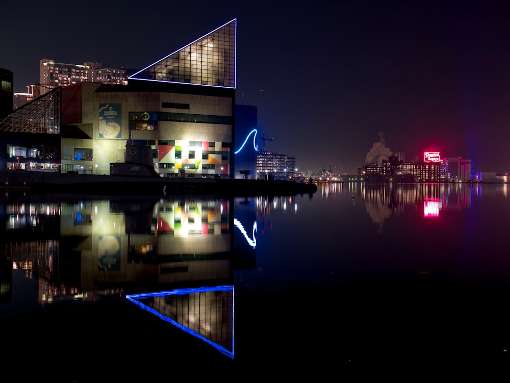 a large body of water with buildings in the background