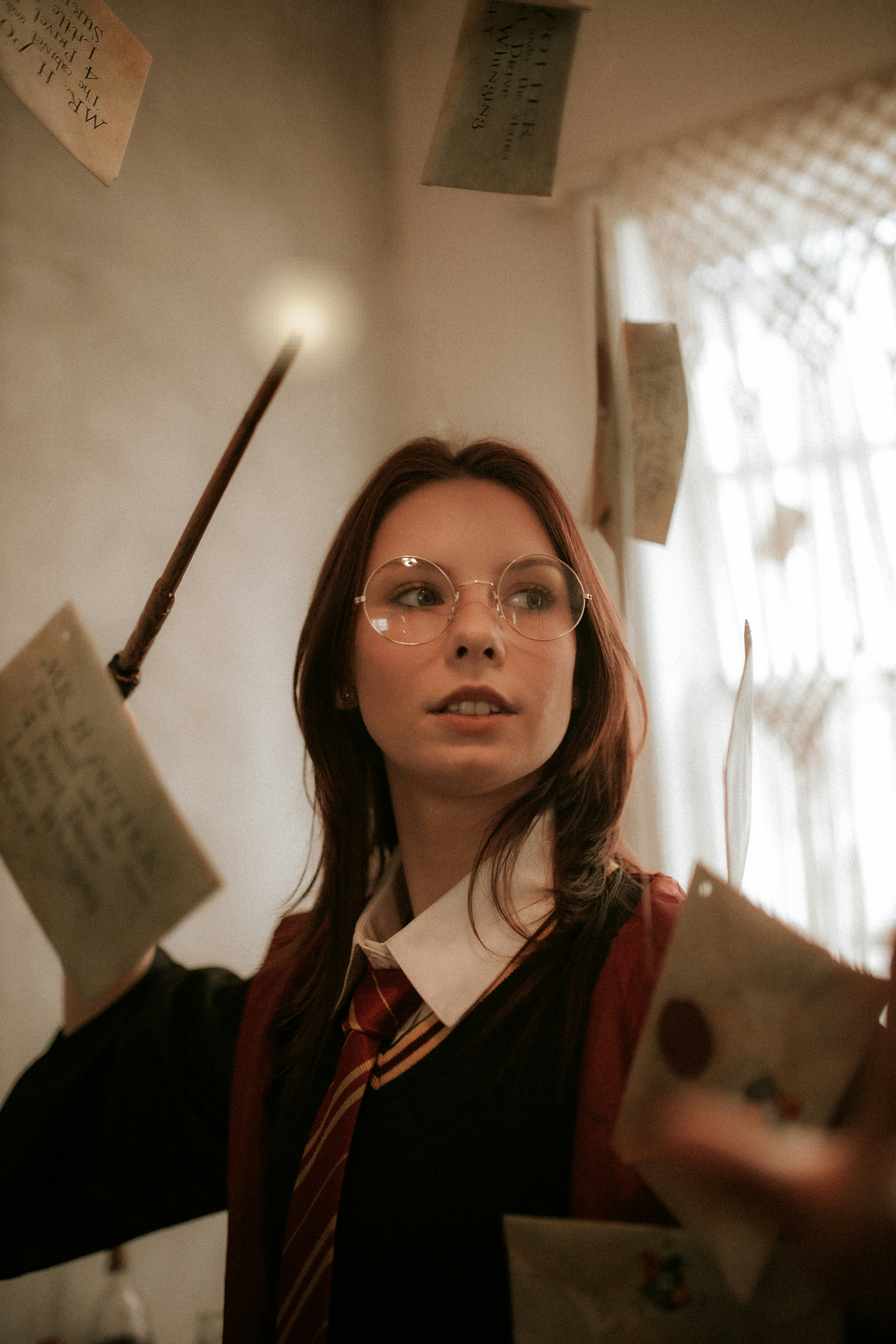 a woman wearing glasses holding a piece of paper