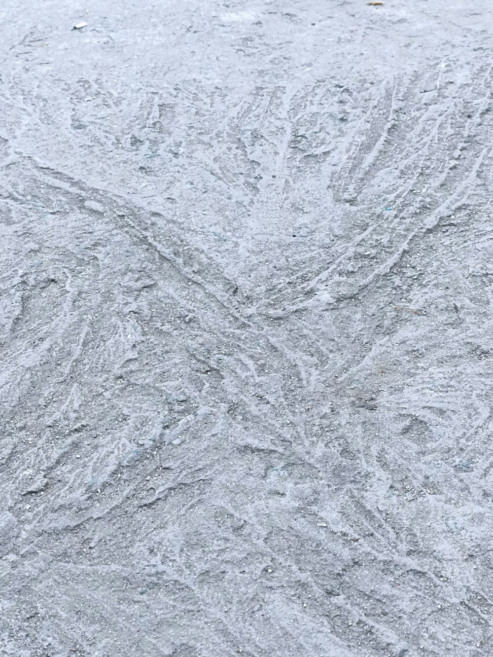 a snowboarder riding down a snow covered slope