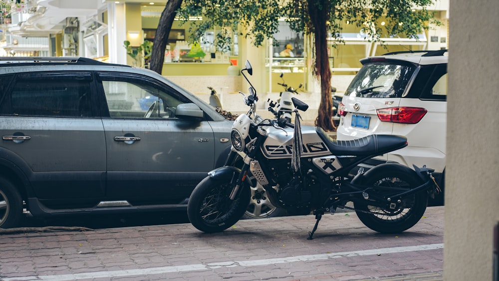 a motorcycle parked next to a car on a street