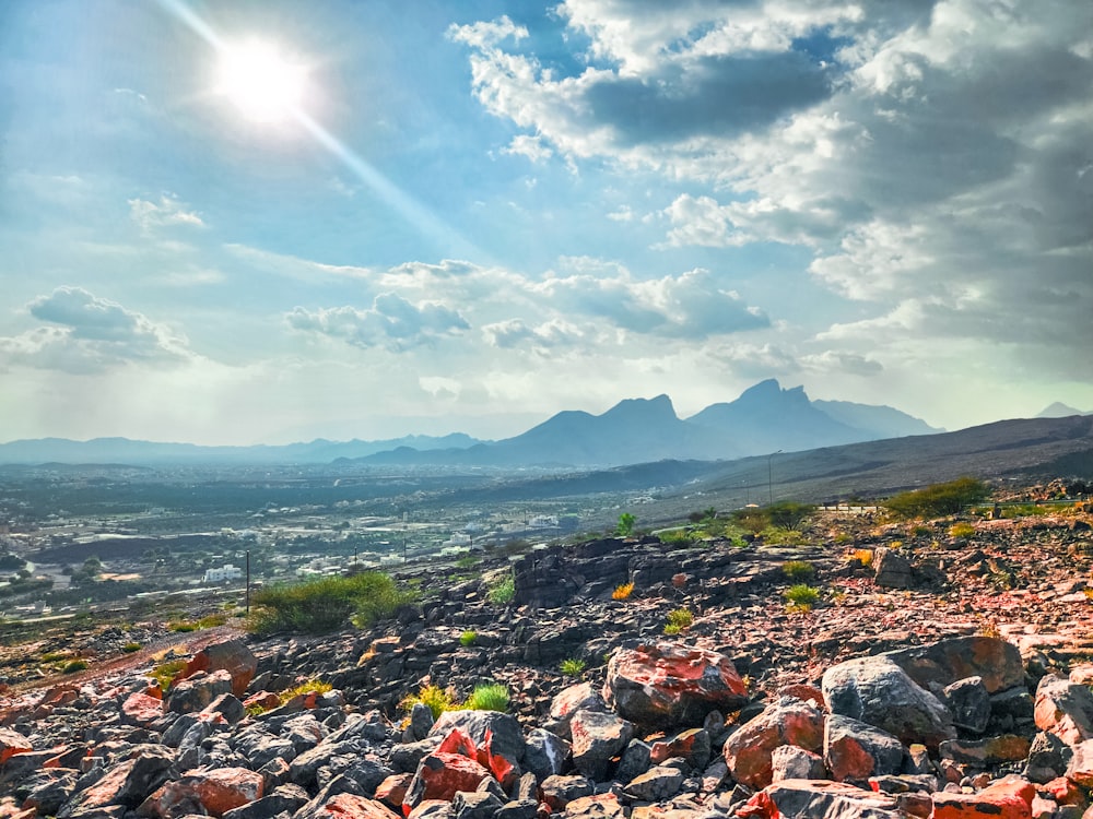 a view of a mountain range with rocks and grass