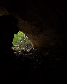 a dark cave with a light at the end of it
