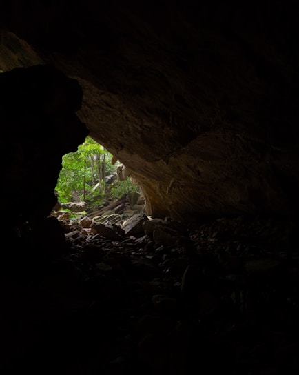 a dark cave with a light at the end of it