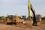 Wide shot of a cleared site with machinery resting after vegetation removal.