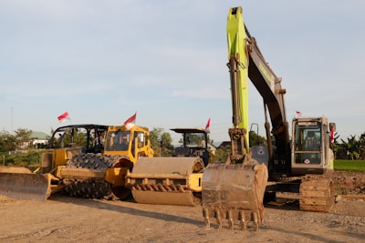 Wide shot of a cleared site with machinery resting after vegetation removal.