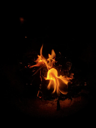 A vibrant orange and yellow flame swirling around a glowing digital marketing icon.
