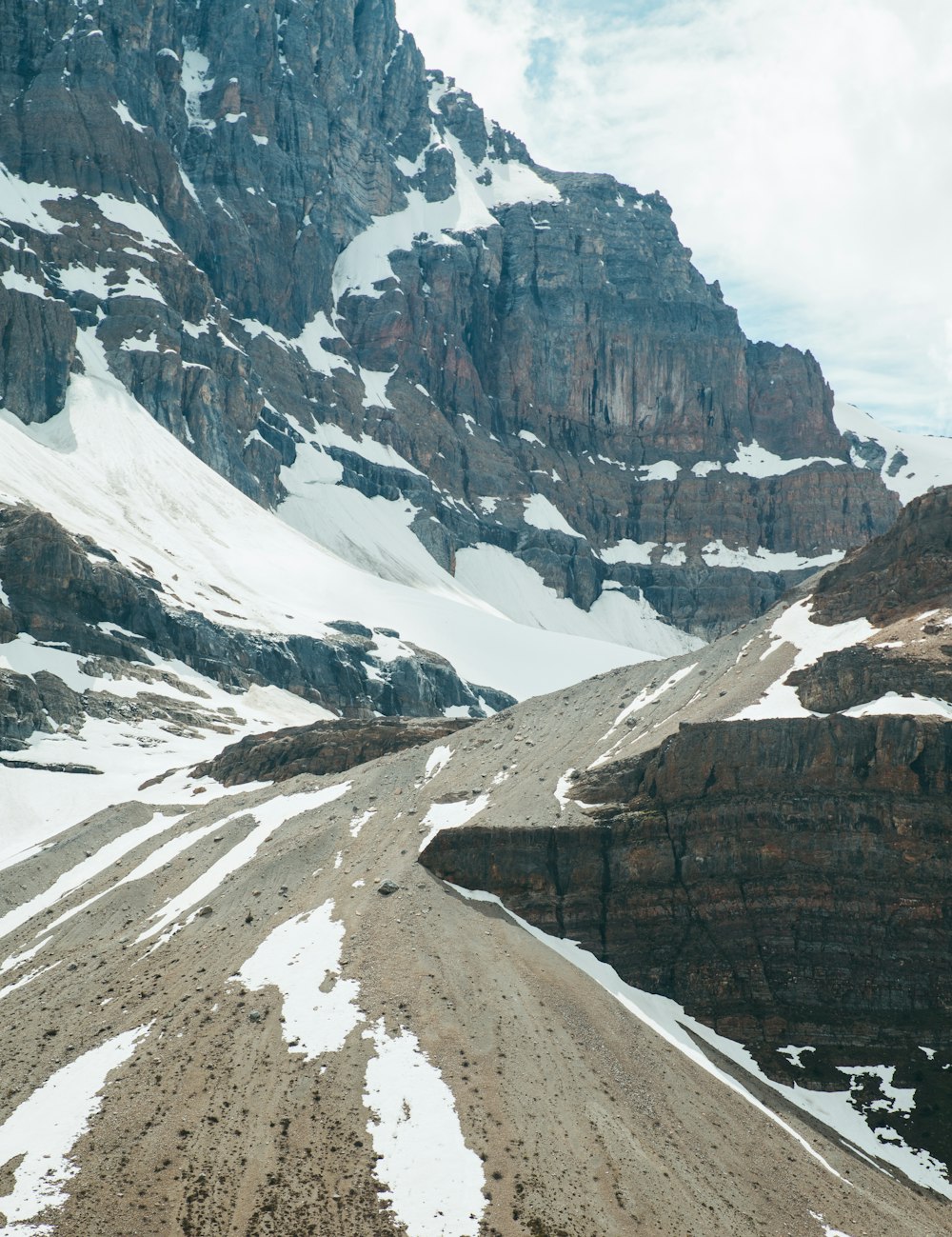 a man riding a snowboard on top of a snow covered mountain