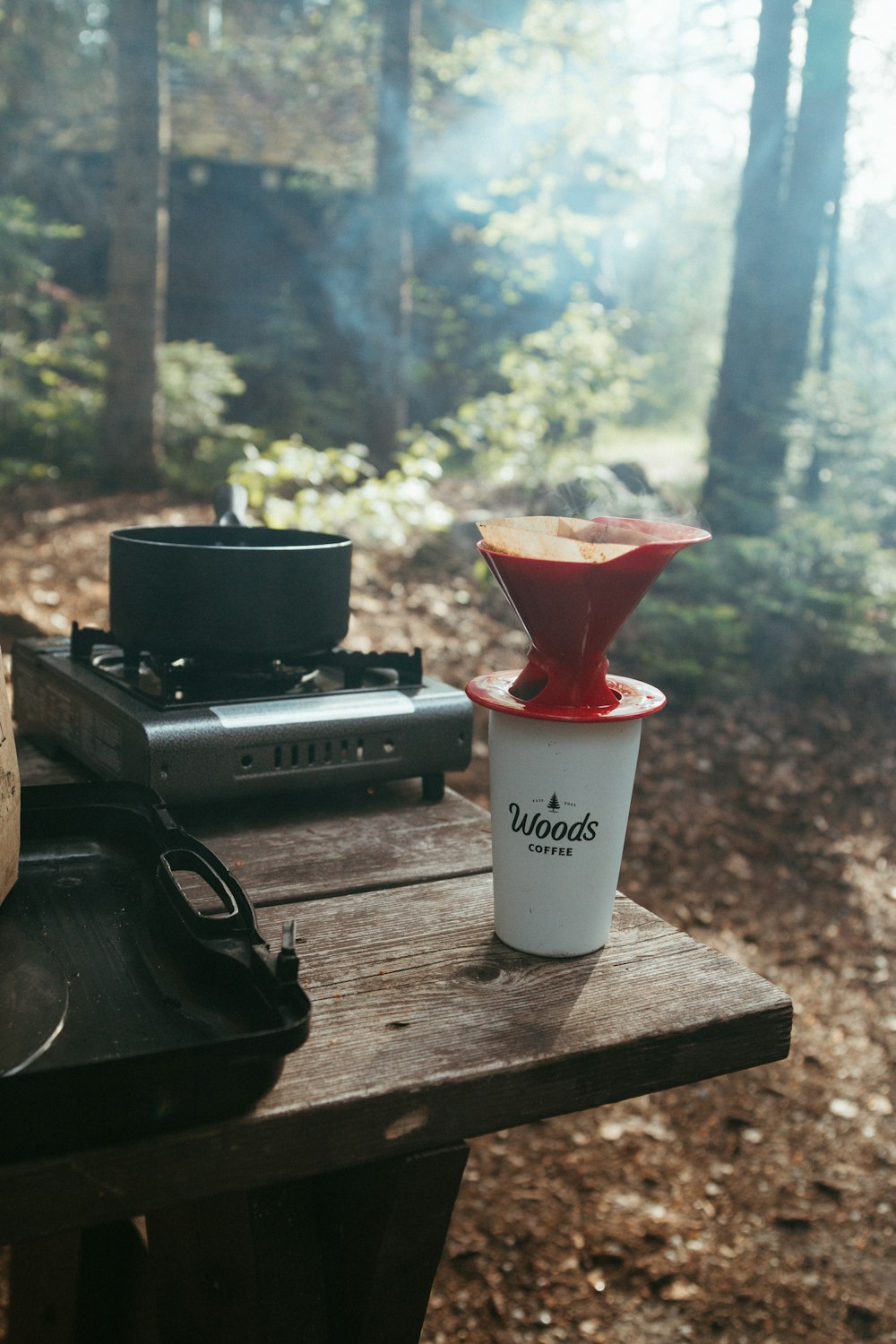 a cup of coffee sitting on top of a wooden table