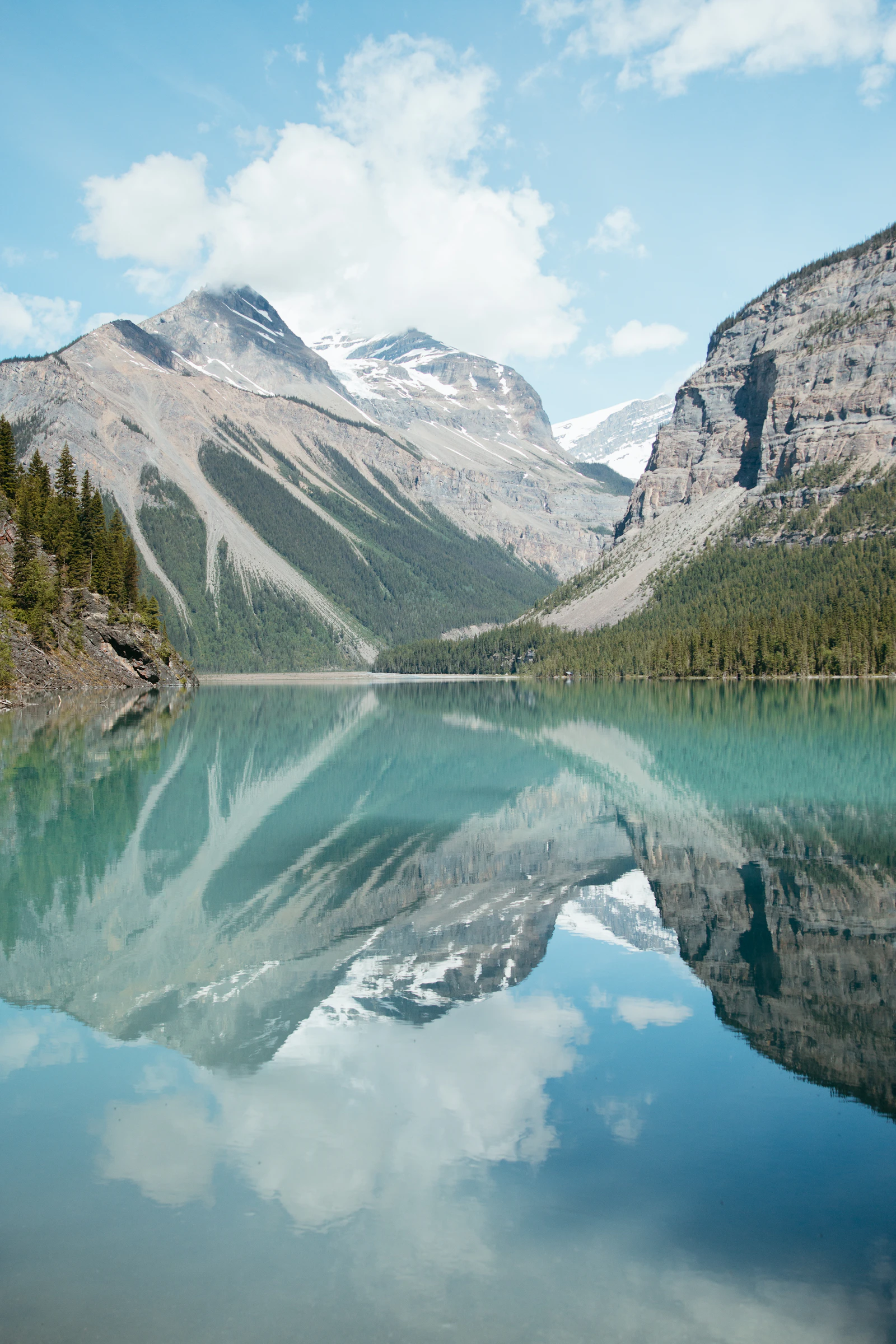 Snow-dusted mountains reflected in Lake Louise in Banff National Park
