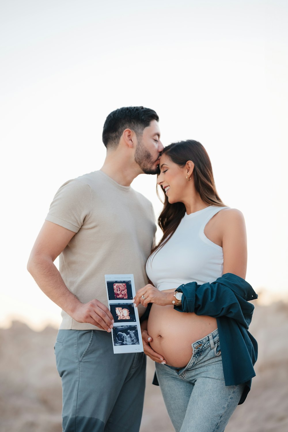 a pregnant couple standing next to each other