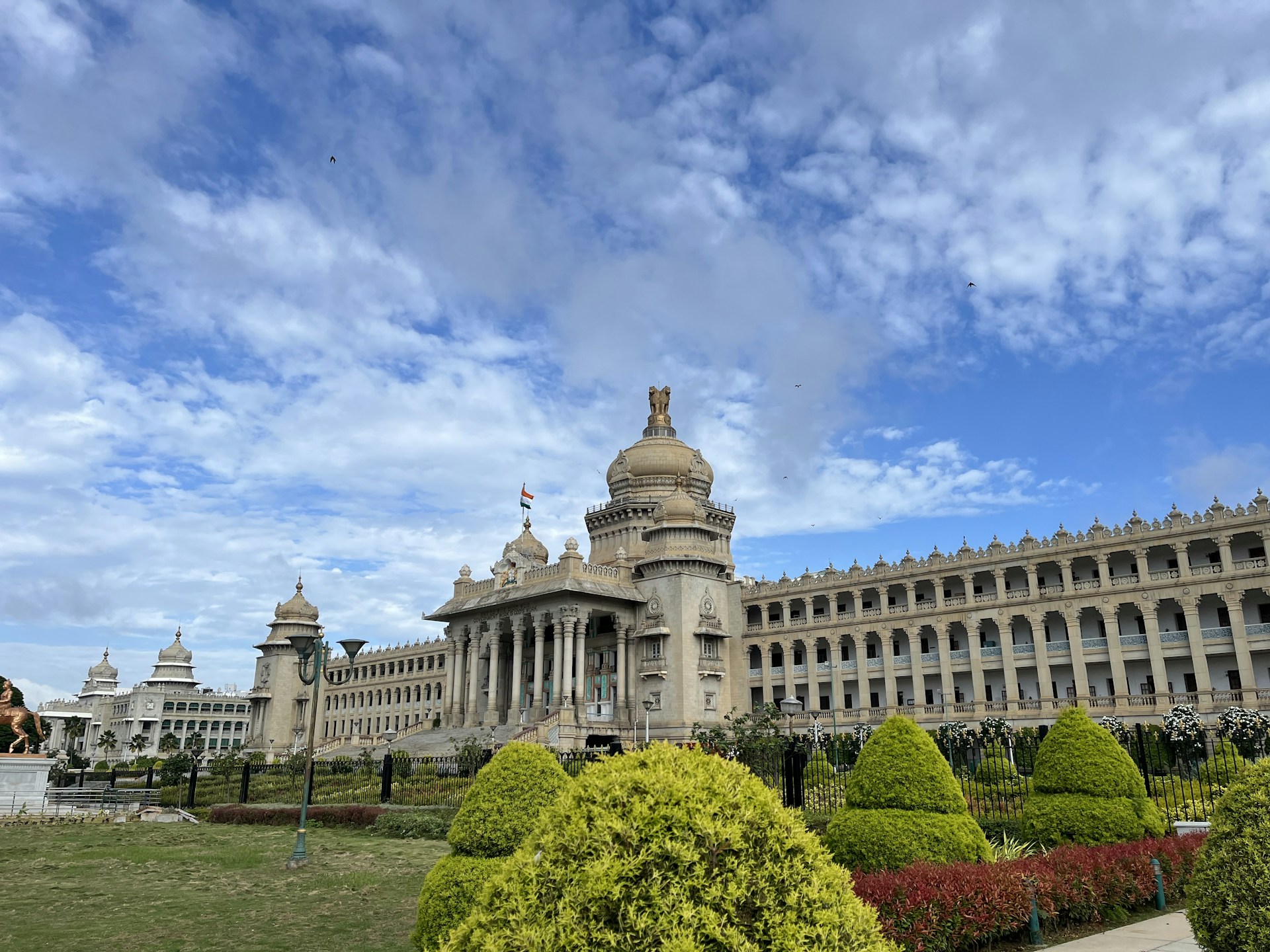 woman wearing yellow long-sleeved dress under white clouds and blue sky during daytime