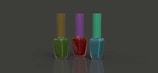 Three nail polish bottles are arranged in a row against a plain dark background. The bottles have different colored polish: green with an olive cap, red with a purple cap, and blue with a teal cap. Each bottle is rectangular with a slender cap, and the surface is reflective.