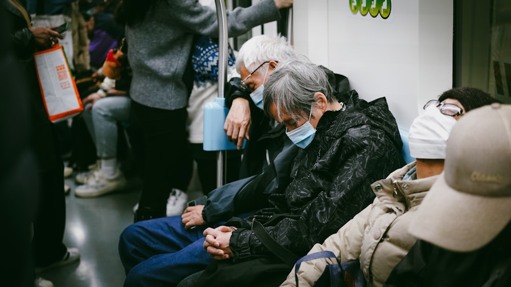 a group of people riding on a subway train