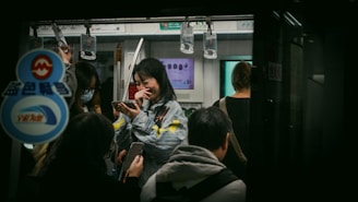 A smiling commuter using the CairoCommute app on their phone while waiting at a busy Cairo bus stop.