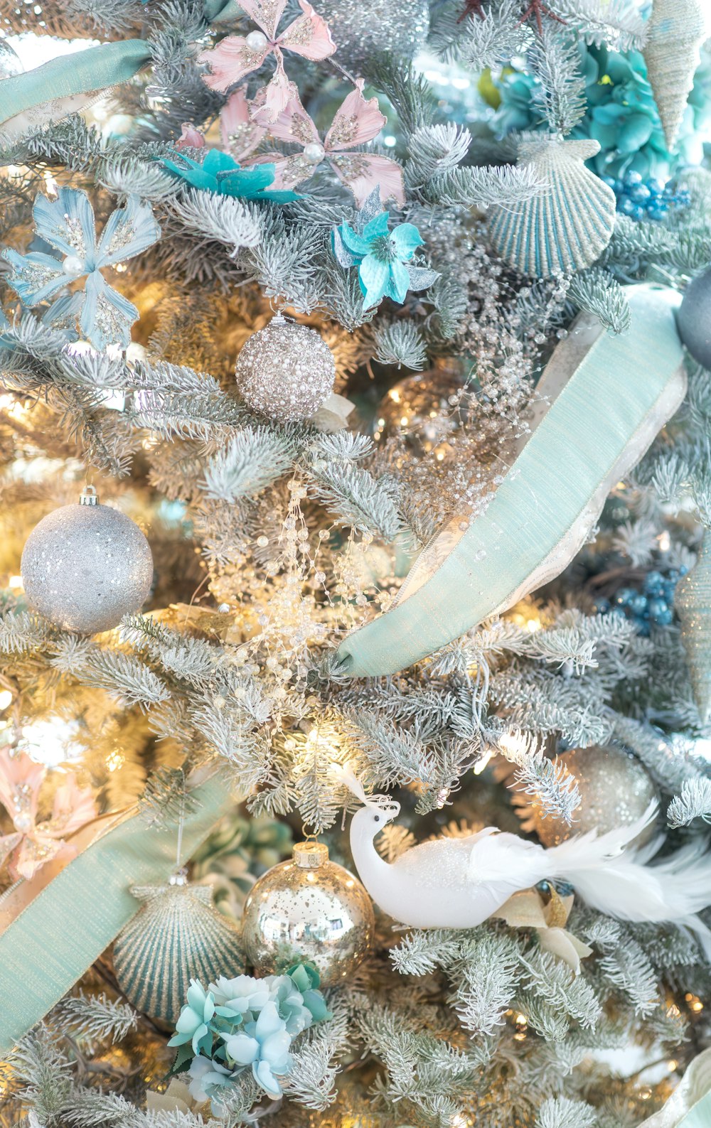 a christmas tree decorated with blue and silver ornaments