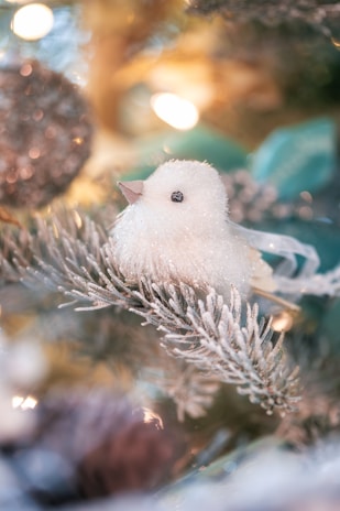 An ornament shaped like a red cardinal, delicately painted with fine brush strokes.