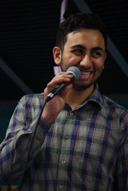 A happy customer holding a microphone with a smile, ready to record.