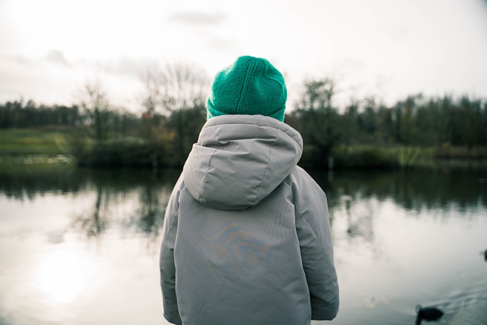 a person standing in front of a body of water