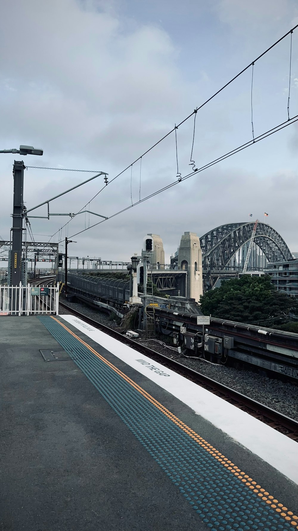 a train on a train track next to a bridge