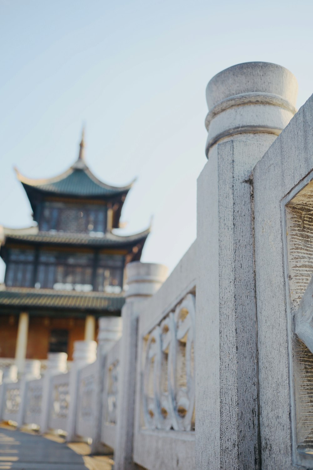 a close up of a fence with a building in the background