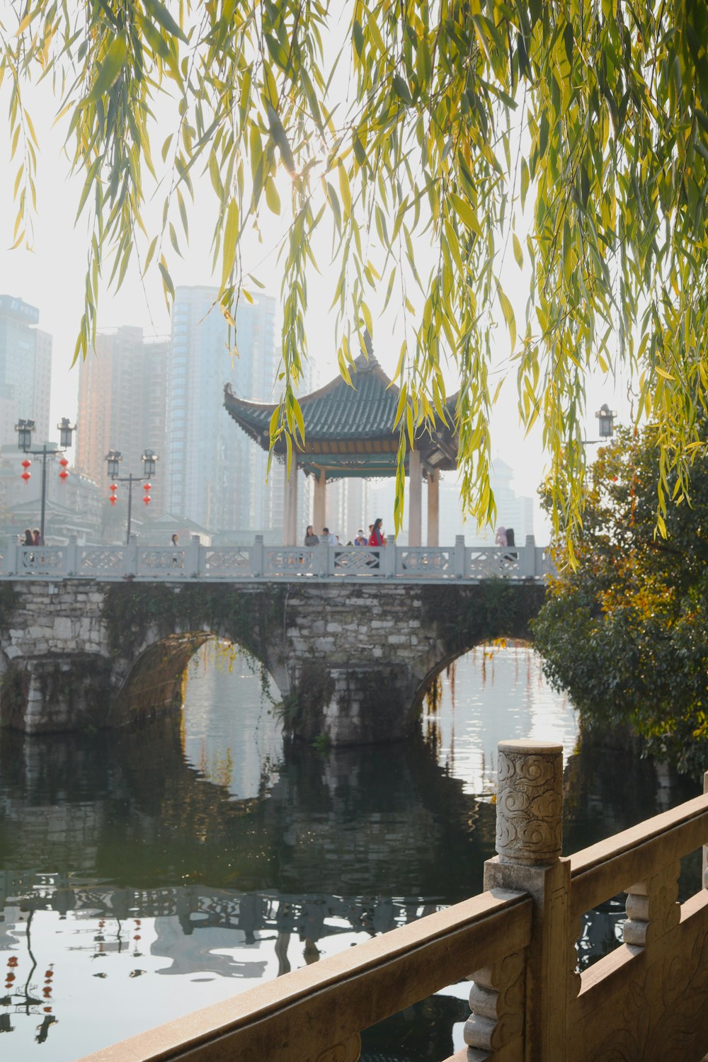 a bridge over a body of water with a building in the background