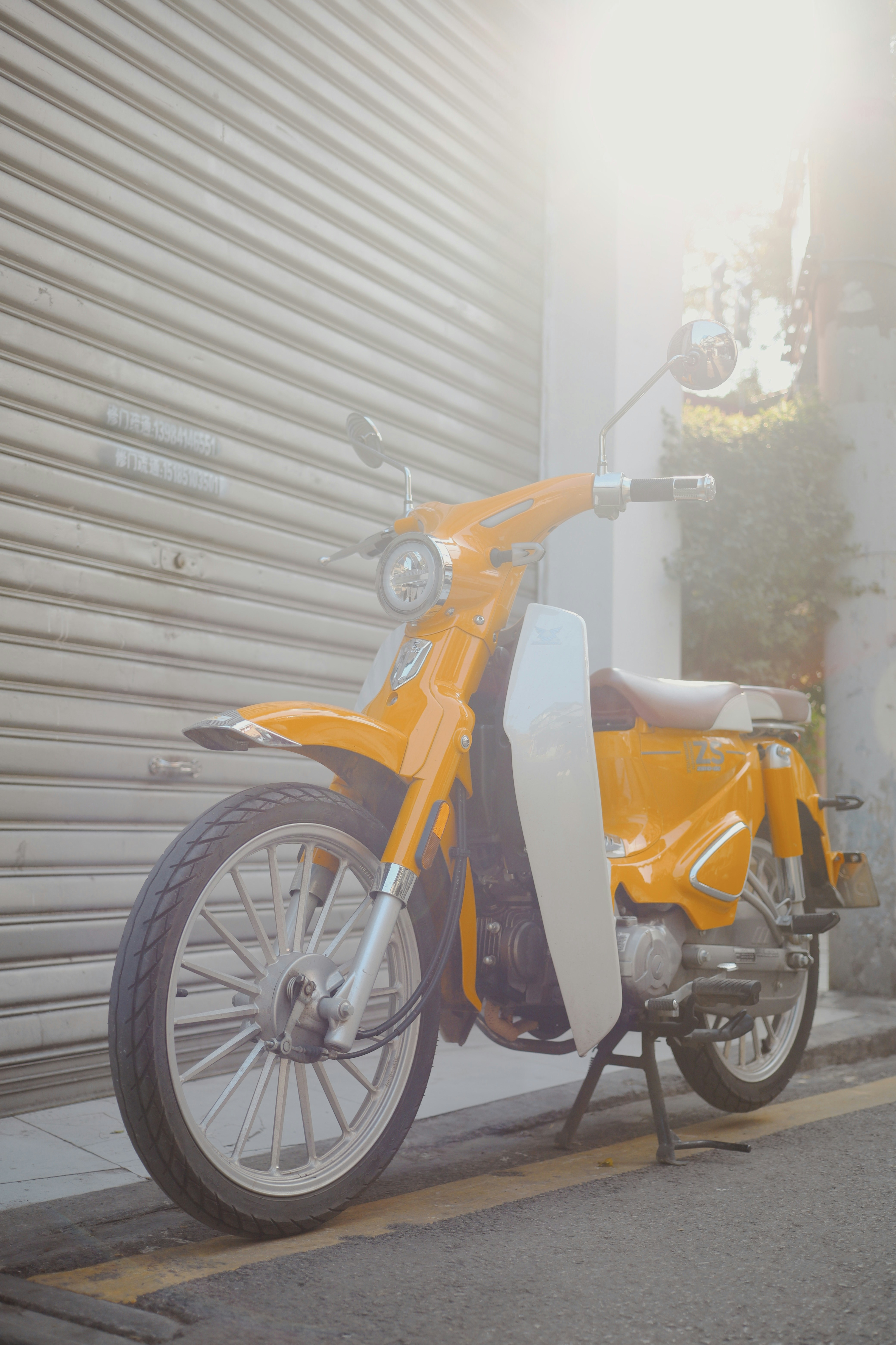 Vintage scooter in bright outdoor setting, sunny day vehicle photography