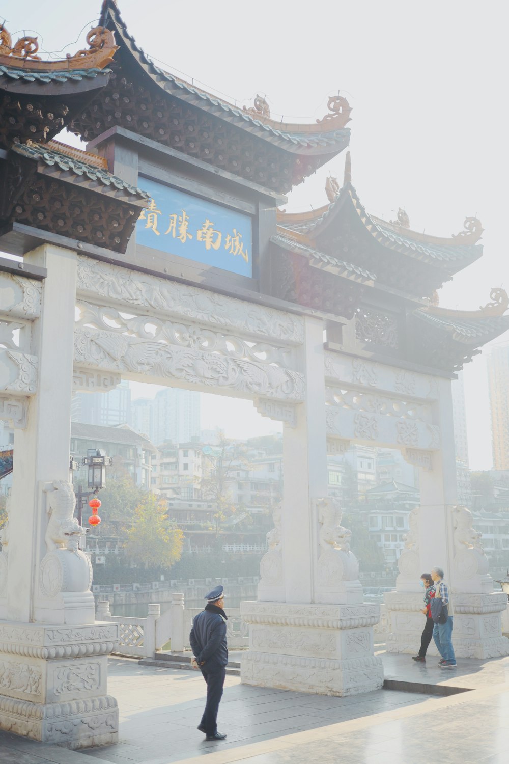 a man standing in front of a white archway