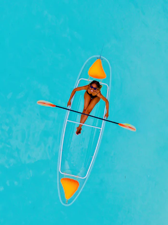 Crystal-clear lagoon waters with a transparent kayak gliding smoothly.