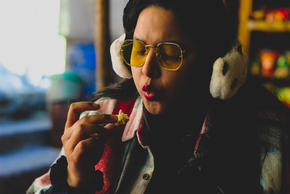 a woman wearing headphones and eating food