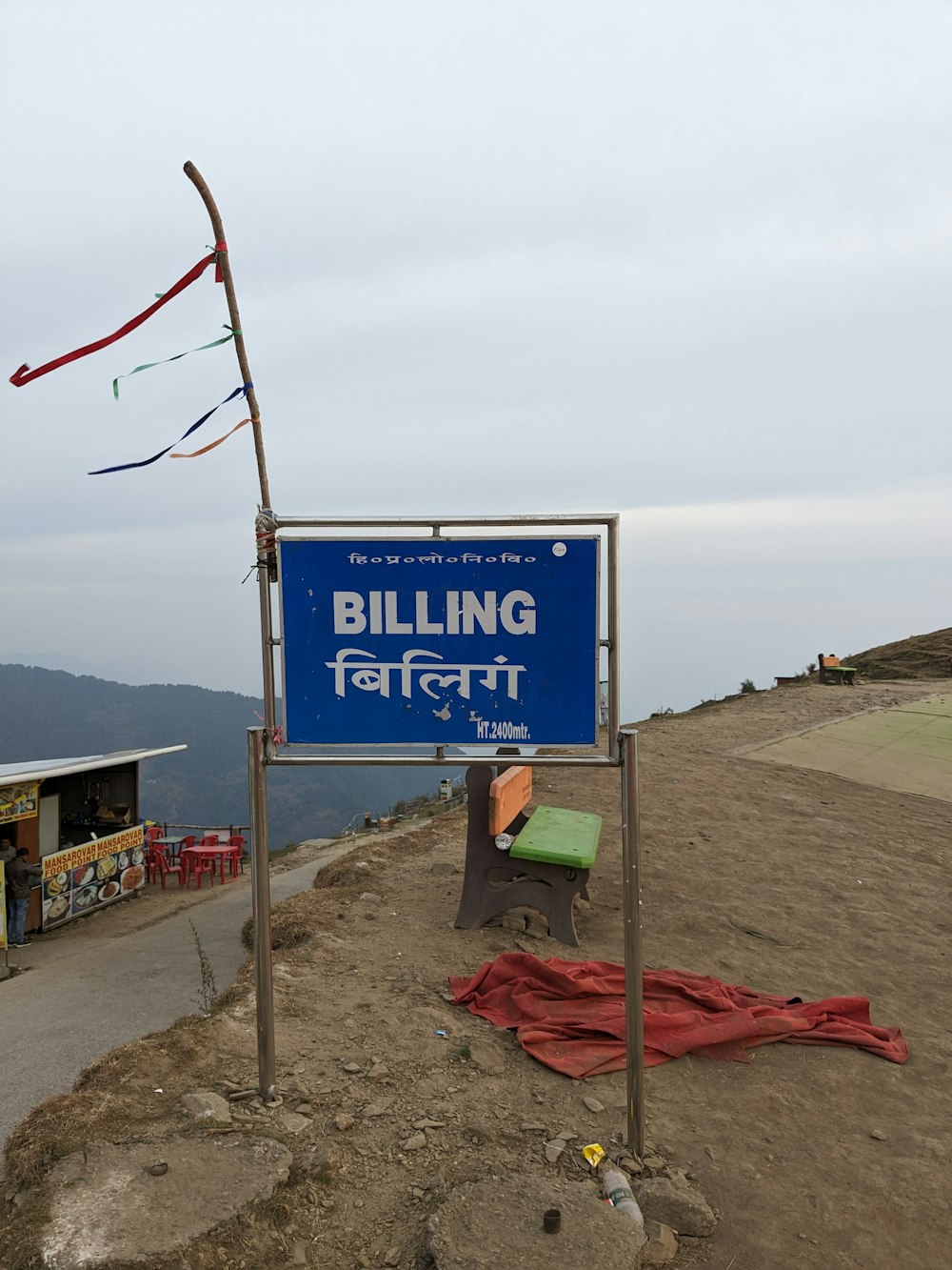 a sign that is on the side of a hill