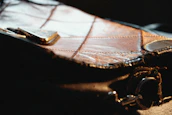 Close-up of a delicate designer label sewn into a preloved chic handbag.