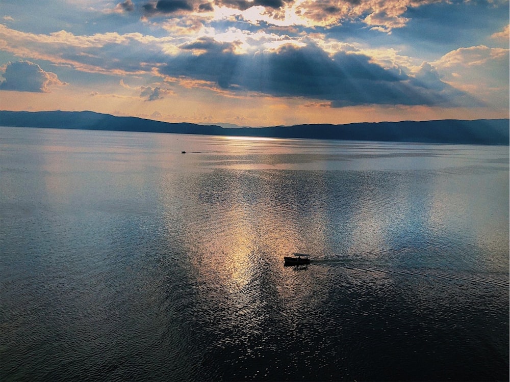 a small boat floating on top of a large body of water