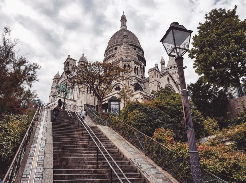 a person walking up a set of stairs in front of a building