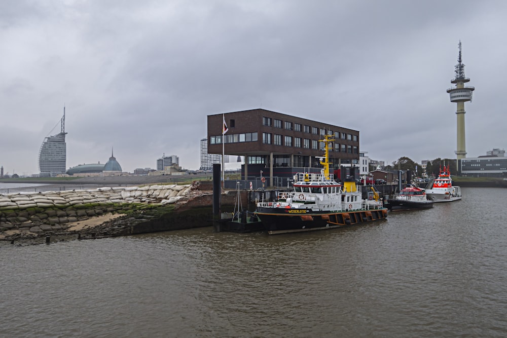 a body of water next to a building with a tower in the background