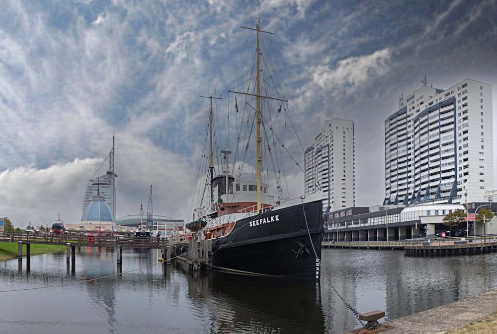 a large boat is docked at a pier