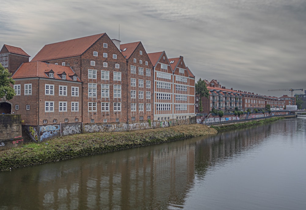 a row of buildings next to a body of water