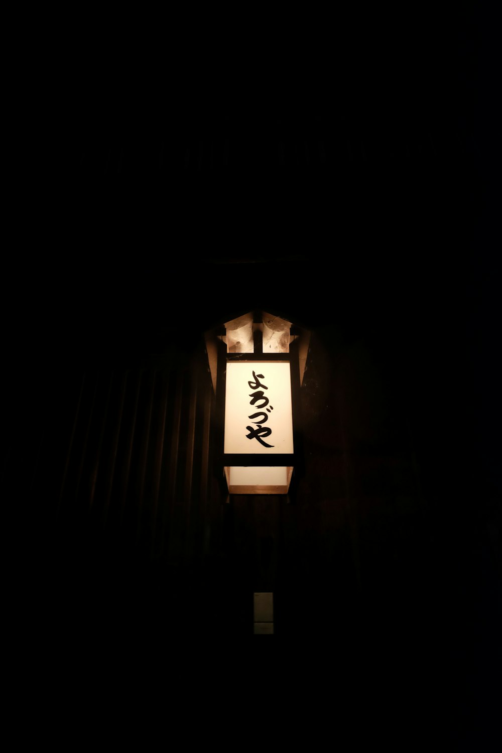 a lantern lit up in the dark with writing on it