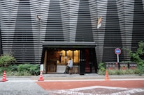 A modern Cleanride kiosk set against a stylish Phuket street backdrop at dusk.