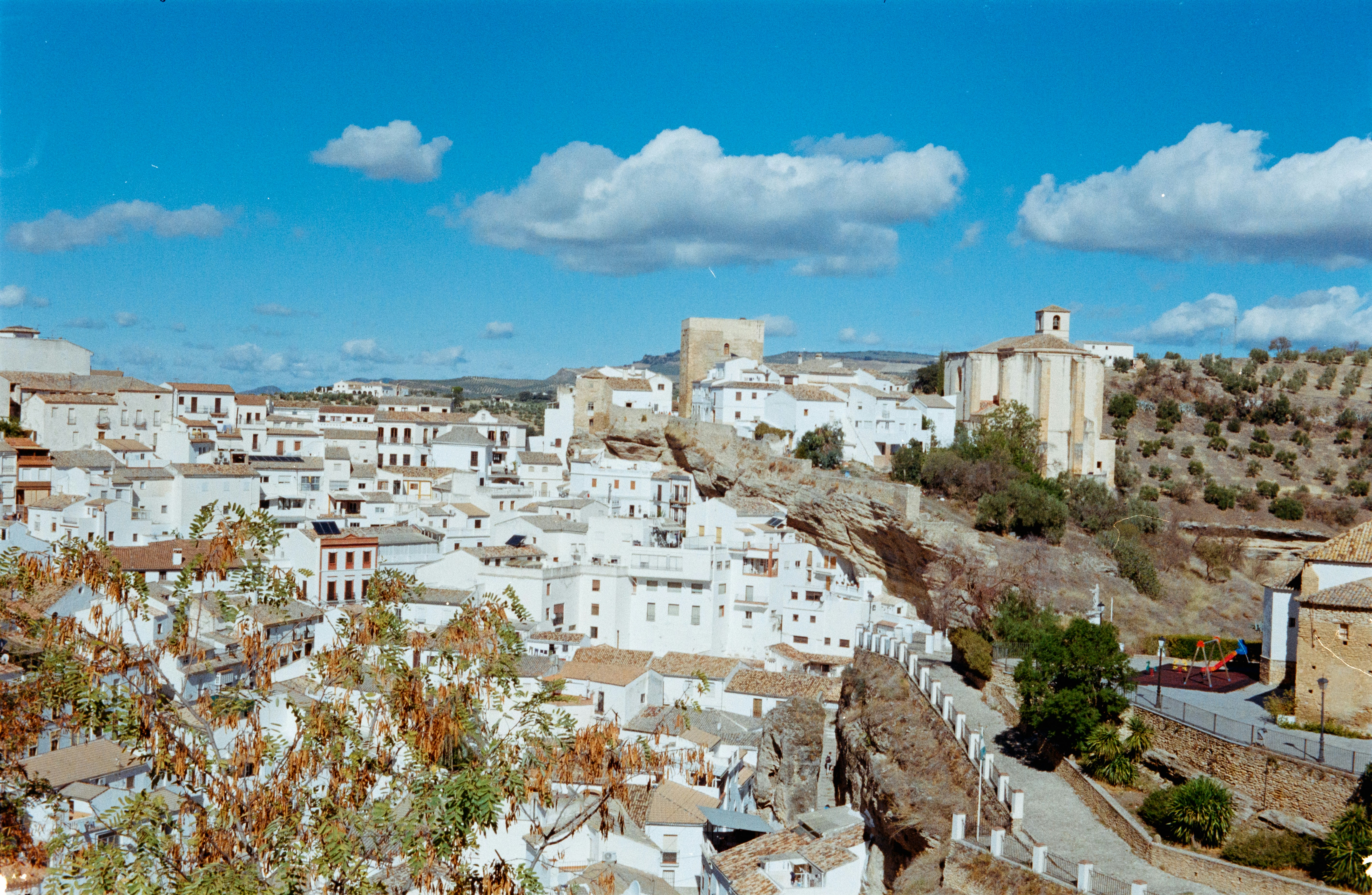 a view of a city with white buildings, Kodak Gold 200