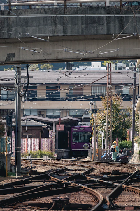 a train traveling down train tracks under a bridge