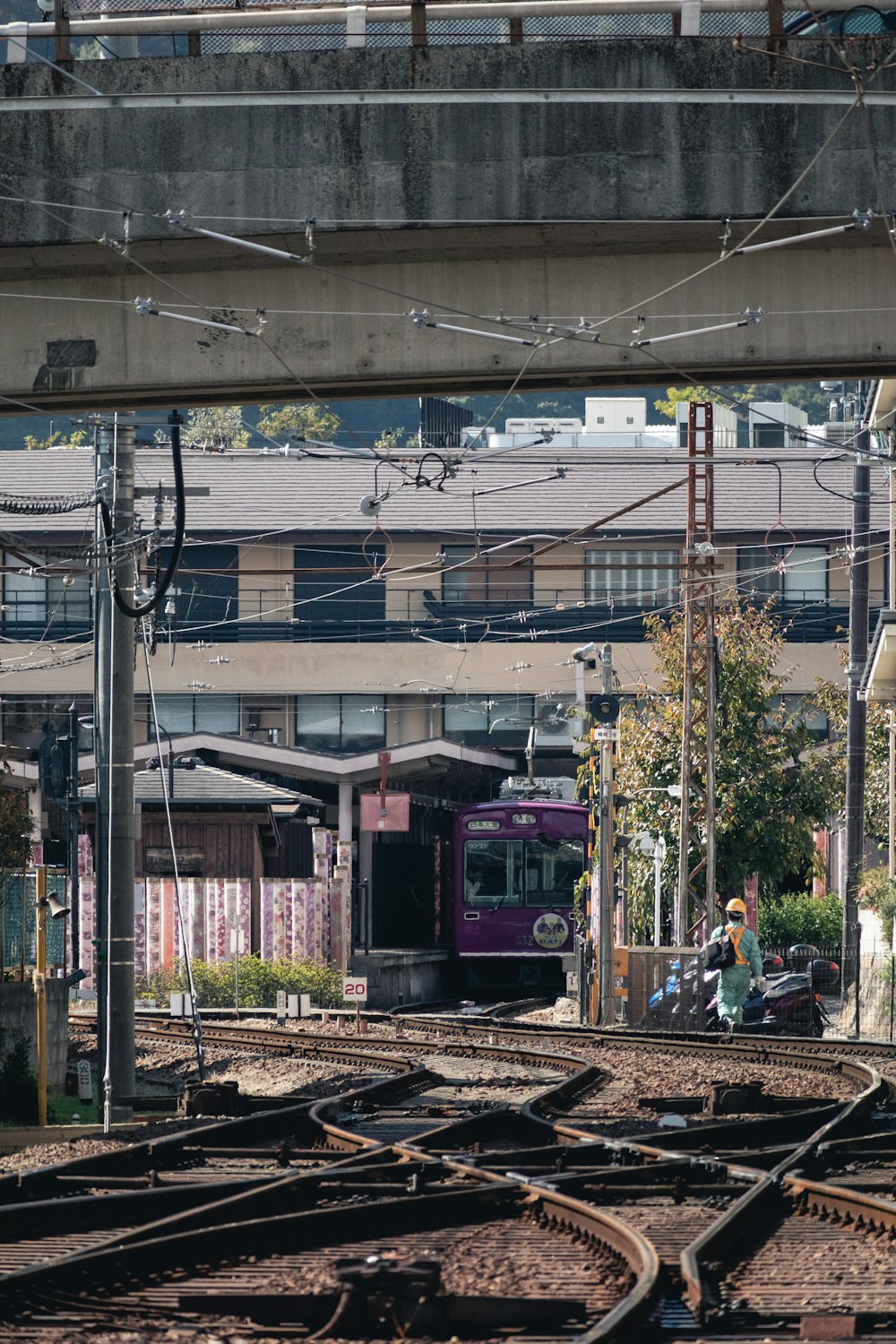 a train traveling down train tracks under a bridge