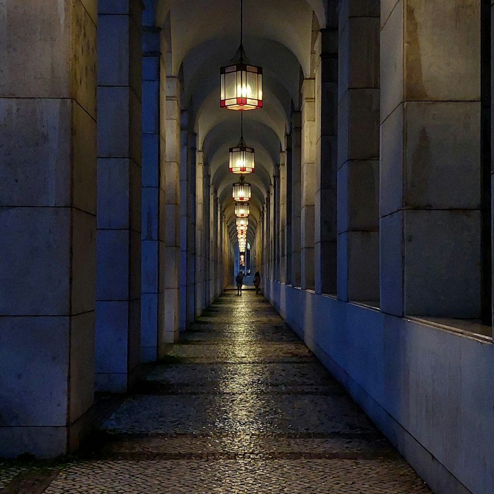 a man is walking down a long hallway