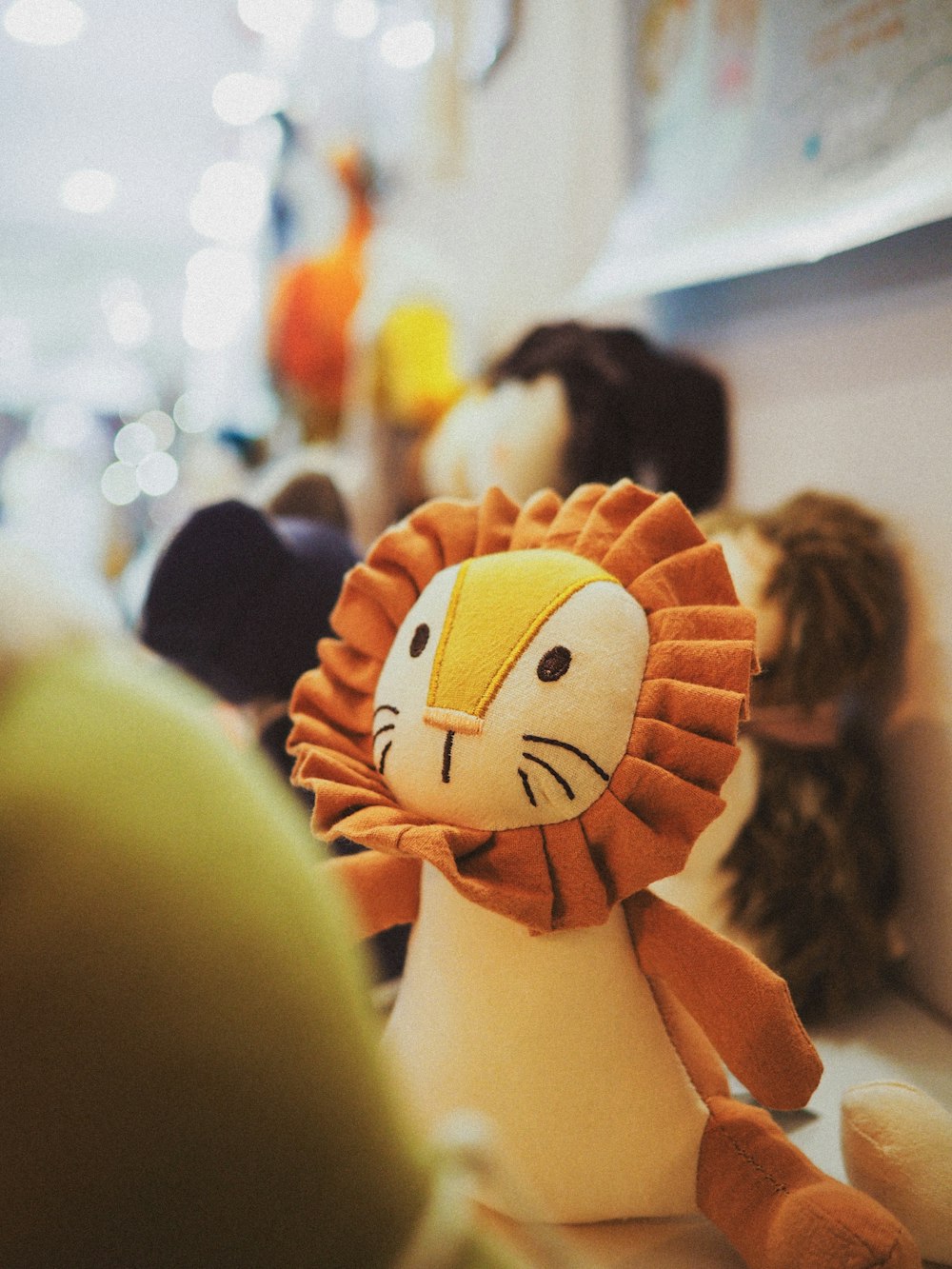 a stuffed lion sitting on top of a table