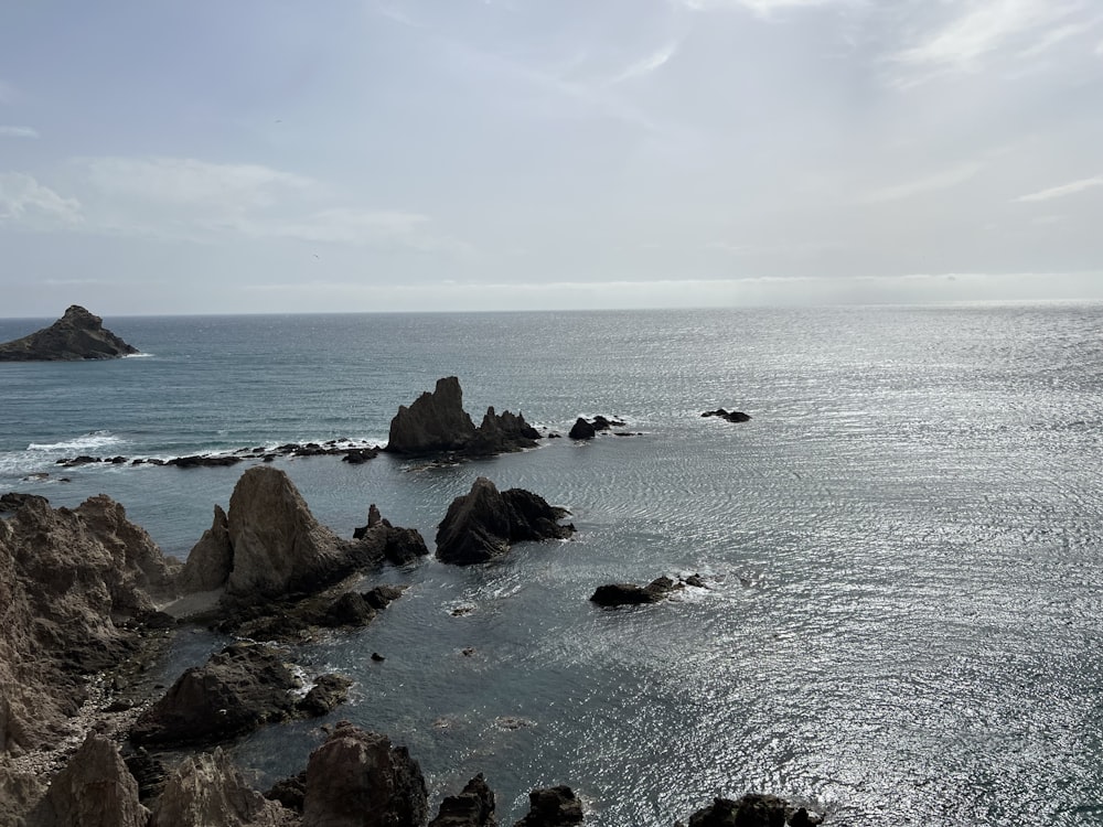 a body of water with rocks in the middle of it