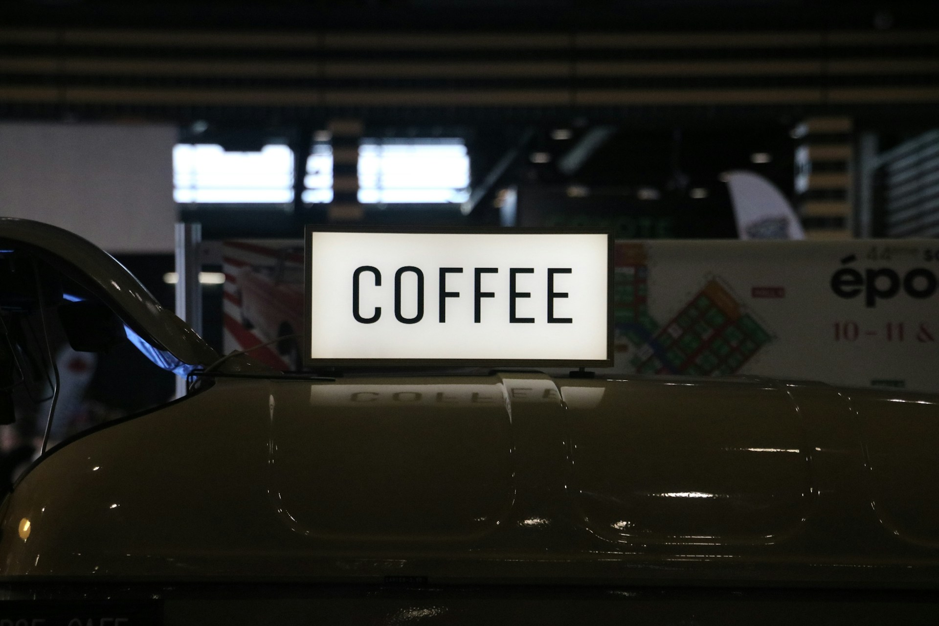 a close up of a coffee sign on a car
