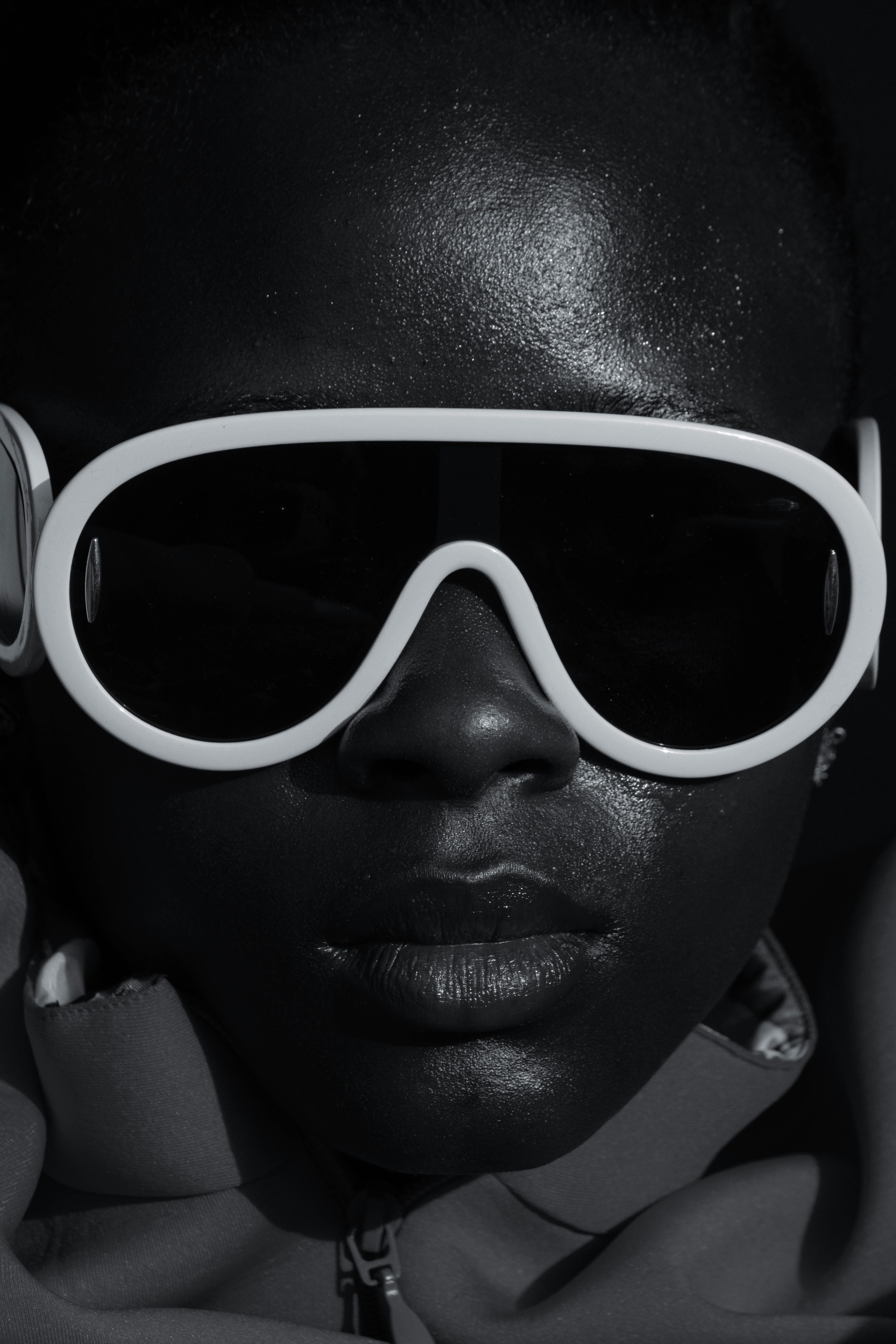 a woman wearing sunglasses and a scarf