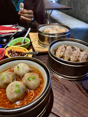 Colorful plates of Chinese dim sum and fried rice arranged in a cozy dining setup.