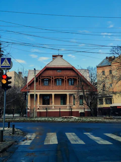 a street corner with a stop light and a house