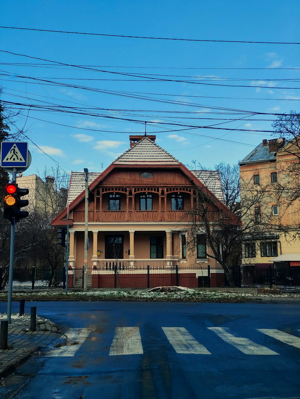 a street corner with a stop light and a house